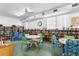 Community library with bookshelves, tables, chairs, and reading materials at 4151 55Th N Way # 1056, Kenneth City, FL 33709
