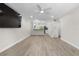 Spacious living room featuring sleek flooring, recessed lighting, and a ceiling fan at 4151 55Th N Way # 1056, Kenneth City, FL 33709