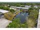 A beautiful aerial shot of a pond on a property with a water feature and lots of surrounding mature trees at 4151 55Th N Way # 1056, Kenneth City, FL 33709