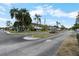 Landscaped condominium complex with tropical palm trees and well-manicured lawns at 4151 55Th N Way # 1056, Kenneth City, FL 33709
