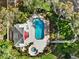 Stunning aerial view of this backyard featuring a pool, spa, and meticulous landscaping at 4208 Edgewood Dr, Holiday, FL 34691