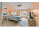 Cozy bedroom with a ceiling fan, tiled floor, and good natural light at 4208 Edgewood Dr, Holiday, FL 34691