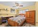 Sunny bedroom with wood furnishings, floral bedding, and bright yellow walls, offering a cozy and inviting space at 4208 Edgewood Dr, Holiday, FL 34691
