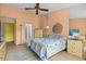 Comfortable bedroom with neutral tones, a ceiling fan, and an attached bathroom at 4208 Edgewood Dr, Holiday, FL 34691