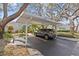Carport and driveway parking with lush tropical landscaping surrounding the house at 4208 Edgewood Dr, Holiday, FL 34691