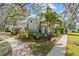 A well maintained home with tropical landscaping, mature trees, and a charming exterior view at 4208 Edgewood Dr, Holiday, FL 34691