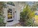 Charming front door with sidelight and address number surrounded by lush greenery at 4208 Edgewood Dr, Holiday, FL 34691