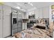 Updated kitchen featuring stainless steel appliances, granite countertops, and modern fixtures at 4208 Edgewood Dr, Holiday, FL 34691
