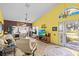Bright living room with vaulted ceilings, tile floors, and access to the outdoor area at 4208 Edgewood Dr, Holiday, FL 34691