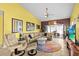 Living area featuring tile floors, a comfortable sofa, and a view into the dining area at 4208 Edgewood Dr, Holiday, FL 34691
