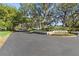 A street view of the Edgewood community entrance with mature trees and landscaping at 4208 Edgewood Dr, Holiday, FL 34691