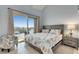 Bedroom features coastal decor, slider to patio with water views, and natural light at 459 Bahia Beach Blvd, Ruskin, FL 33570