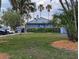 Charming Hook's restaurant set amidst lush greenery and towering palm trees, evoking a relaxed atmosphere at 459 Bahia Beach Blvd, Ruskin, FL 33570