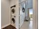 A laundry room featuring a stackable washer and dryer in a well-lit space at 459 Bahia Beach Blvd, Ruskin, FL 33570