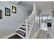 Stairway with dark brown steps and white risers leading to the upper floor of the residence at 459 Bahia Beach Blvd, Ruskin, FL 33570