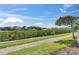 Scenic waterfront view with lush greenery, beautiful homes, and clear blue sky at 459 Bahia Beach Blvd, Ruskin, FL 33570
