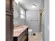 Bathroom featuring a shower, marble countertop, vanity and a grey tile surround at 4851 W Gandy Blvd # B3 L8, Tampa, FL 33611