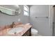 Bathroom featuring marble countertop vanity, sink, and tiled shower, designed for comfort and style at 4851 W Gandy Blvd # B3 L8, Tampa, FL 33611