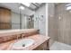 Bathroom featuring a sink, shower, marble countertop, vanity with a mirror and grey tile surround at 4851 W Gandy Blvd # B3 L8, Tampa, FL 33611