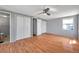 Bedroom showcasing hardwood floors, a ceiling fan, and ample closet space, creating a serene retreat at 4851 W Gandy Blvd # B3 L8, Tampa, FL 33611