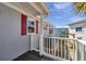 A home's exterior featuring red shutters and an outdoor AC unit on a sunny day at 4851 W Gandy Blvd # B3 L8, Tampa, FL 33611