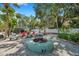 Outdoor fire pit area with lush landscaping, offering a cozy spot for residents to gather and relax at 4851 W Gandy Blvd # B3 L8, Tampa, FL 33611