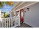 Charming home with a bright red front door and a well-maintained porch area at 4851 W Gandy Blvd # B3 L8, Tampa, FL 33611