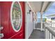 Welcoming front entrance with a decorative oval-windowed red door and cozy porch at 4851 W Gandy Blvd # B3 L8, Tampa, FL 33611