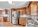 Well-lit kitchen with stainless steel appliances and wooden cabinets with a convenient layout at 4851 W Gandy Blvd # B3 L8, Tampa, FL 33611
