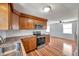 Beautiful kitchen with stainless steel appliances, wooden cabinets, and vinyl wood flooring at 4851 W Gandy Blvd # B3 L8, Tampa, FL 33611
