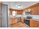 Bright kitchen featuring stainless steel appliances, wood cabinets, and white subway tile at 4851 W Gandy Blvd # B3 L8, Tampa, FL 33611
