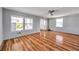 Open living room boasts wood-look flooring, lots of natural light, and fresh paint at 4851 W Gandy Blvd # B3 L8, Tampa, FL 33611