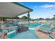 Outdoor community swimming pool with lounge chairs and tables under a covered area for relaxing and socializing at 4851 W Gandy Blvd # B3 L8, Tampa, FL 33611