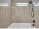 Tiled shower with small window and upgraded shower head, a luxury home spa experience at 4851 W Gandy Blvd # B3 L8, Tampa, FL 33611