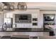 Stylish bar area featuring sleek countertops, stainless steel appliances, and modern lighting fixtures at 6223 Baywood Ct, Bradenton, FL 34211