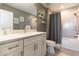 Bathroom with white vanity, quartz countertop, and shower/tub combination with gray tile surround at 6223 Baywood Ct, Bradenton, FL 34211