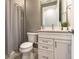 Bathroom with white vanity, quartz countertop, gray walls, and shower with gray tile surround at 6223 Baywood Ct, Bradenton, FL 34211
