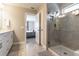 Bright bathroom with large walk-in shower, gray tiling, and double vanity with quartz countertop at 6223 Baywood Ct, Bradenton, FL 34211