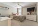 Bright bedroom featuring a ceiling fan, large dresser, and natural light from the window at 6223 Baywood Ct, Bradenton, FL 34211