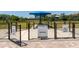 Community dog park with separate areas for large and small dogs, featuring shaded areas at 6223 Baywood Ct, Bradenton, FL 34211