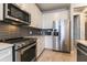 Well-equipped kitchen featuring stainless steel appliances, stone backsplash, and ample counter space at 6223 Baywood Ct, Bradenton, FL 34211