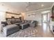 Open-concept living room with a large sectional sofa, stylish rug, and views into the modern kitchen at 6223 Baywood Ct, Bradenton, FL 34211