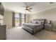 Main bedroom with carpet flooring, gray walls, and large windows overlooking the property at 6223 Baywood Ct, Bradenton, FL 34211
