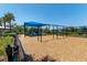 Community playground with swings and play structure set in a safe, wood-chip ground at 6223 Baywood Ct, Bradenton, FL 34211