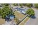 This aerial view features a home with solar panels, a fenced backyard, and a screened-in patio at 7015 Cobblewood Ct, Tampa, FL 33615