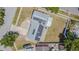 Bird's-eye view of the house displaying solar panels, driveway, lawn, and surrounding neighborhood from above at 7015 Cobblewood Ct, Tampa, FL 33615