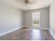 Bedroom with wood-look floors, ceiling fan and a window with natural light at 7015 Cobblewood Ct, Tampa, FL 33615