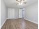 Bedroom featuring laminate floors, double closets, ceiling fan, and neutral walls at 7015 Cobblewood Ct, Tampa, FL 33615