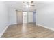 Bedroom with wood-look floors, ceiling fan, barn door leading to the bathroom, and natural light at 7015 Cobblewood Ct, Tampa, FL 33615