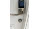 Modern electronic door lock with handle and key access on white front door at 7015 Cobblewood Ct, Tampa, FL 33615